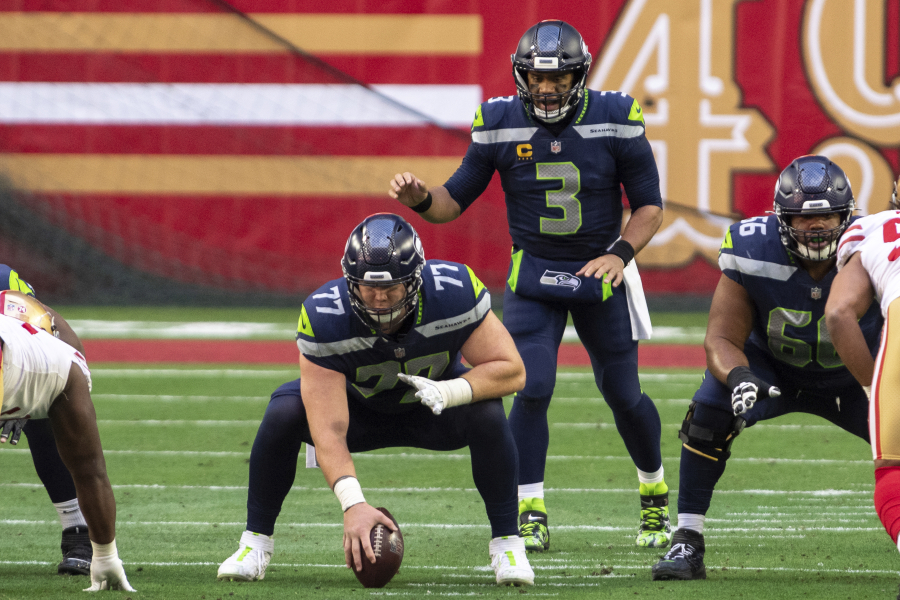 Seattle Seahawks center Ethan Pocic (77) prepares to snap the ball to quarterback Russell Wilson (3) during an NFL football game against the San Francisco 49ers, Sunday, Jan. 3, 2021, in Glendale, Ariz.