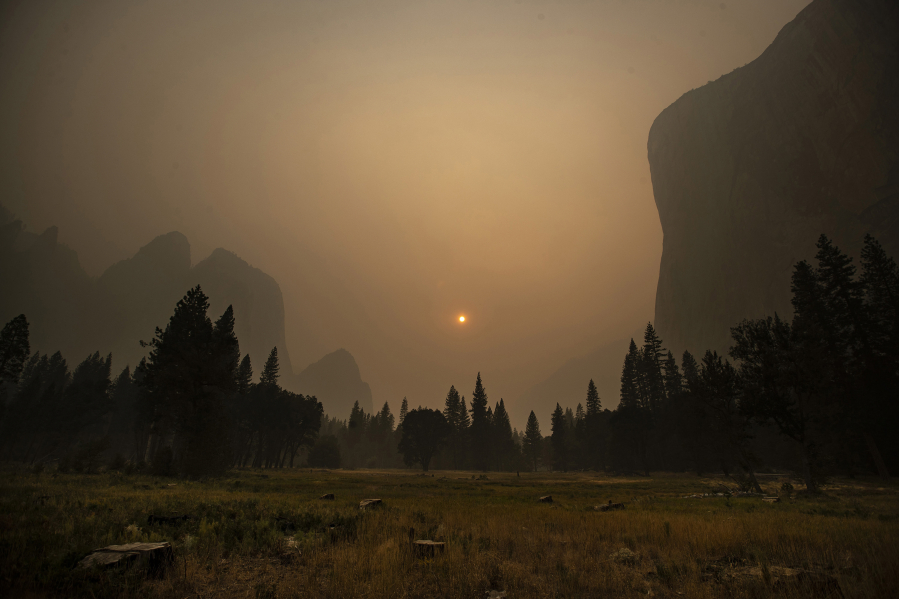 Thick smoke from multiple forest fires shrouds iconic El Capitan, right, and the granite walls of Yosemite Valley on Sept. 12 in Yosemite National Park, Calif.