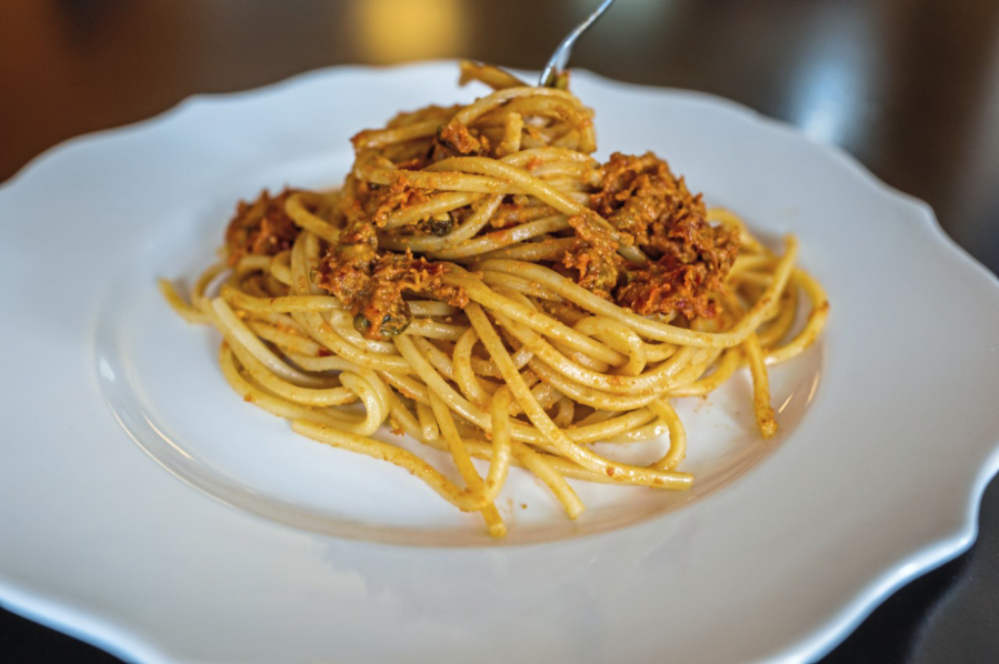 Spaghetti served with piquant sun-dried tomatoes and pistachio pesto.