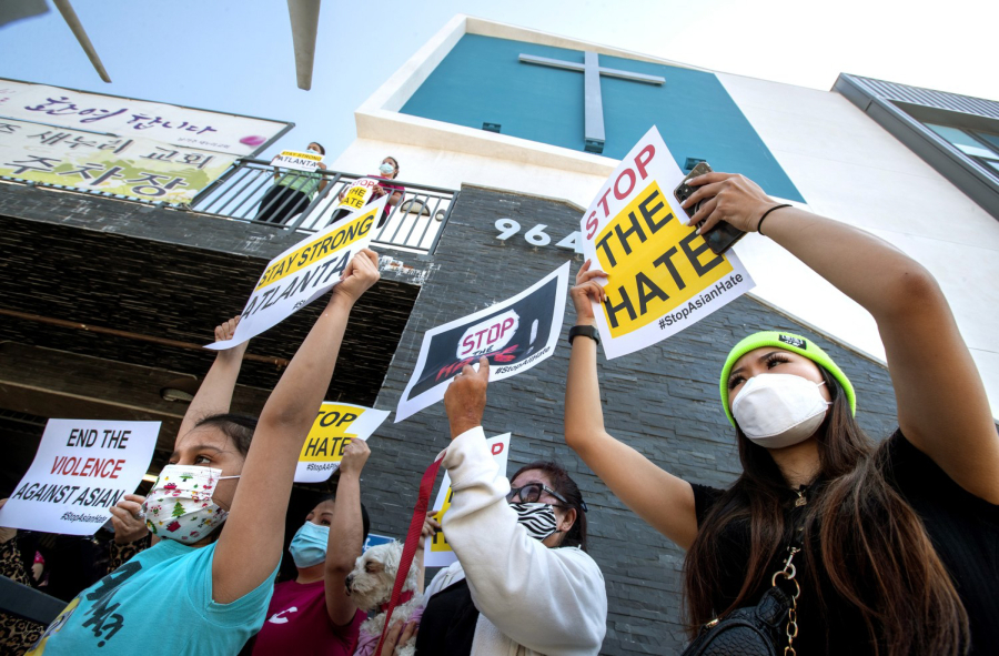 Olivia Lee, 24, right, joins members of the Korean American Federation of Los Angeles and their supporters during a news conference at Berendo Street Baptist Church in Los Angeles to denounce hate against Asian American and Pacific Islander communities.
