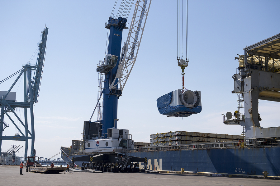 Crews unload a nacelle, the piece where the blades and turbine of a wind turbine meet, from a ship at the Port of Vancouver in March 2019. The port has sought to position itself as a major wind energy import destination in recent years.