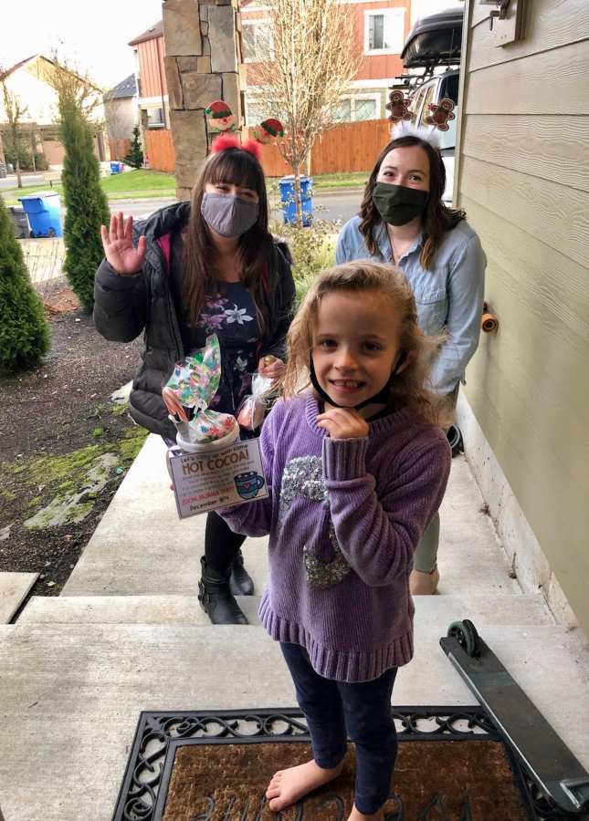 RIDGEFIELD: Teacher Shandel Oderman, right, and student teacher Briana Lewellen drop off a weekly learning packet for Timber Engstrom -- including a special treat and an invitation to the class Zoom Pajama Party.