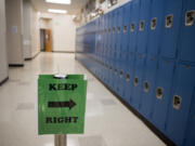 Amanda Cowan/The Columbian 
 A hallway sign encourages students to walk on the right and give their classmates space at Evergreen High School on Tuesday morning.