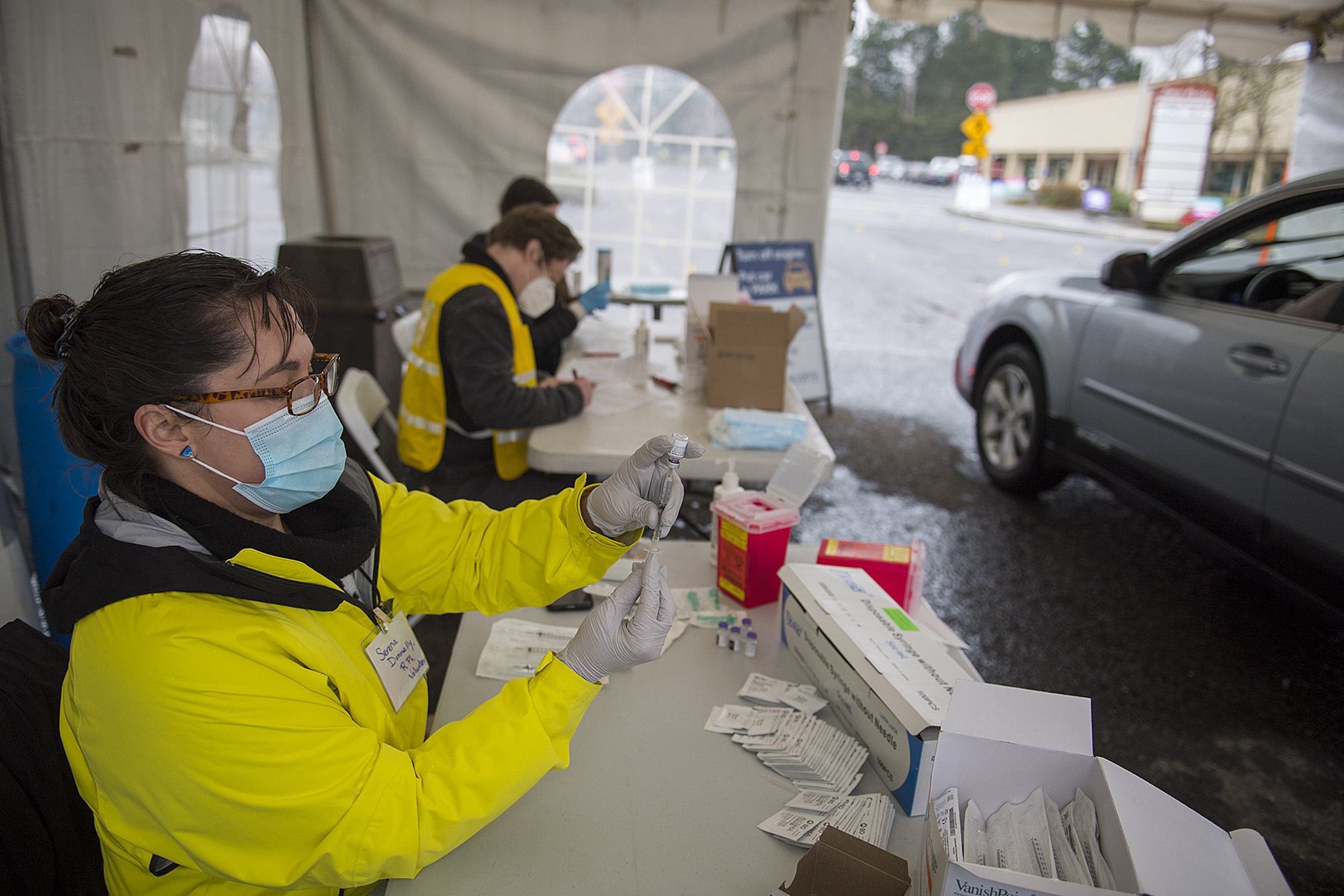 Volunteer pharmacist Serena Donnelly, left, prepares a dose of COVID-19 vaccine while working behind-the-scenes at the new large-scale vaccination site at Tower Mall on Friday morning, March 5, 2021. The vaccinations are by appointment only.