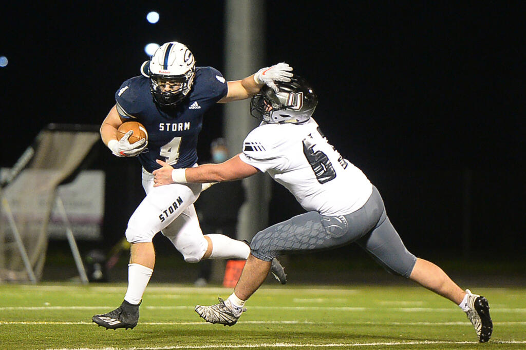 Skyview running back Gabe Martin stiff arms Union's Jack Grimsted at Kiggins Bowl on Friday night, March 12, 2021.