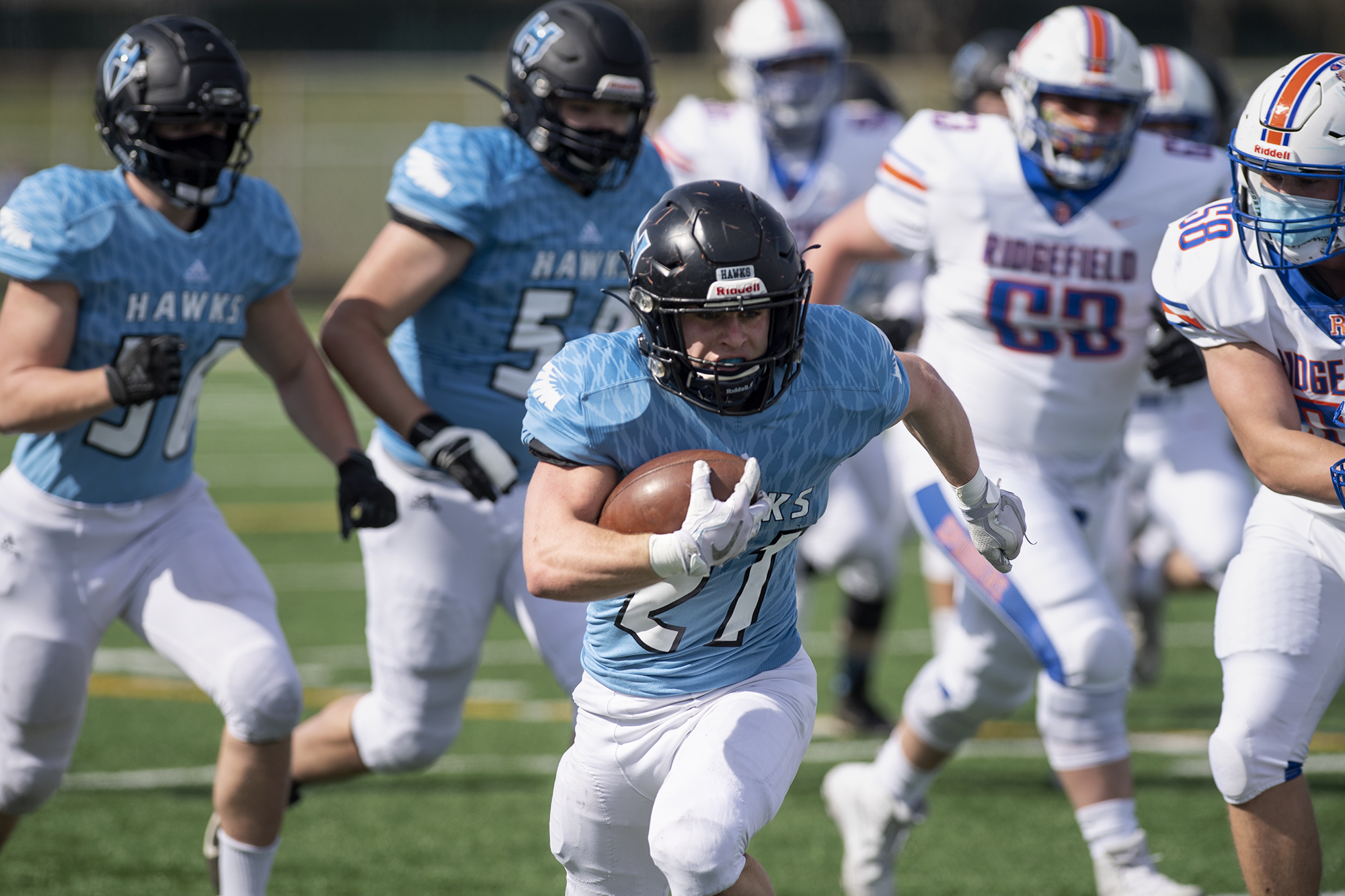 Hockinson’s Daniel Thompson scampers away from the rest of the pack as he rumbles to a first-quarter touchdown on Saturday, March 13, 2021, at District Stadium in Battle Ground. Hockinson won 14-7 in the game between the 2A Greater St. Helens League’s top two teams.
