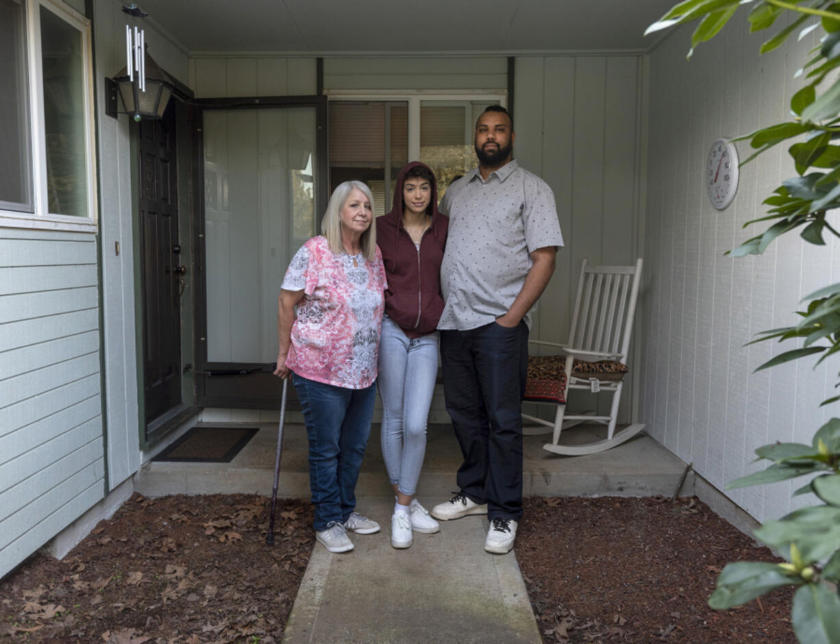Robin Meyers, Tia Lee, 16, and Mychal Jones stand outside their Vancouver rental home on Saturday. Jones has fallen $14,000 behind on rent since he lost his second job during the pandemic and is hoping to work out a payment plan with the landlord.