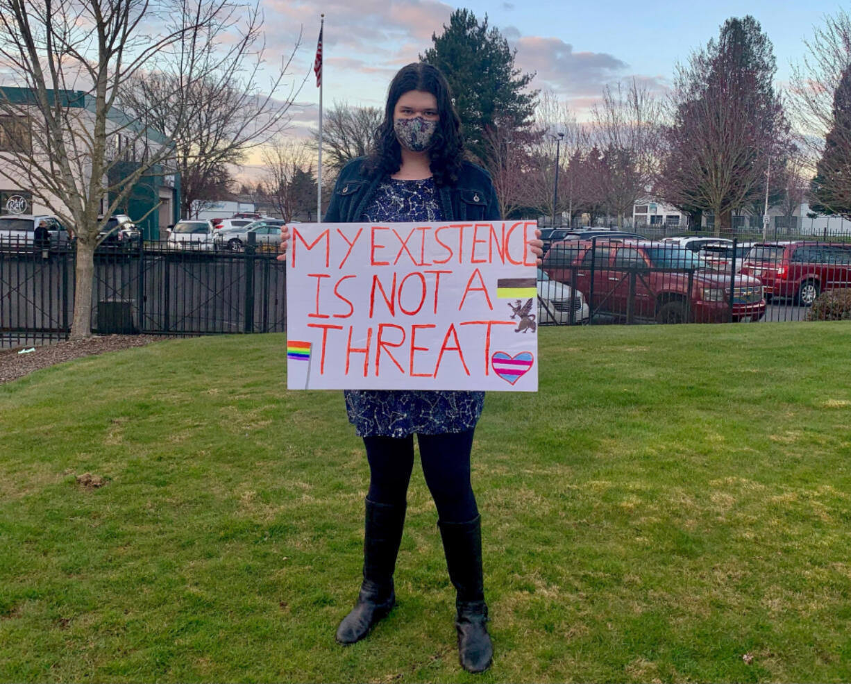 Lucy Lauser, a Democrat running for Congress in Washington&#039;s 3rd Congressional District and a transgender woman, poses with a sign.
