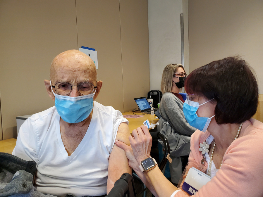 Earl Bolton receives his second dose of the COVID-19 vaccine in late March at Legacy Salmon Creek Medical Center in Salmon Creek.