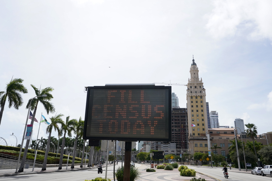 FILE - In this Oct. 5, 2020 file photo, a flashing sign near the iconic &quot;Freedom Tower,&quot; advises people to fill out their census forms in downtown Miami.  The U.S. Census Bureau said it won&#039;t be delivering data used for redrawing state and local legislative districts until the end of September 2021. That will cause headaches for state lawmakers and redistricting commissions facing deadlines to redraw state legislative districts this year.