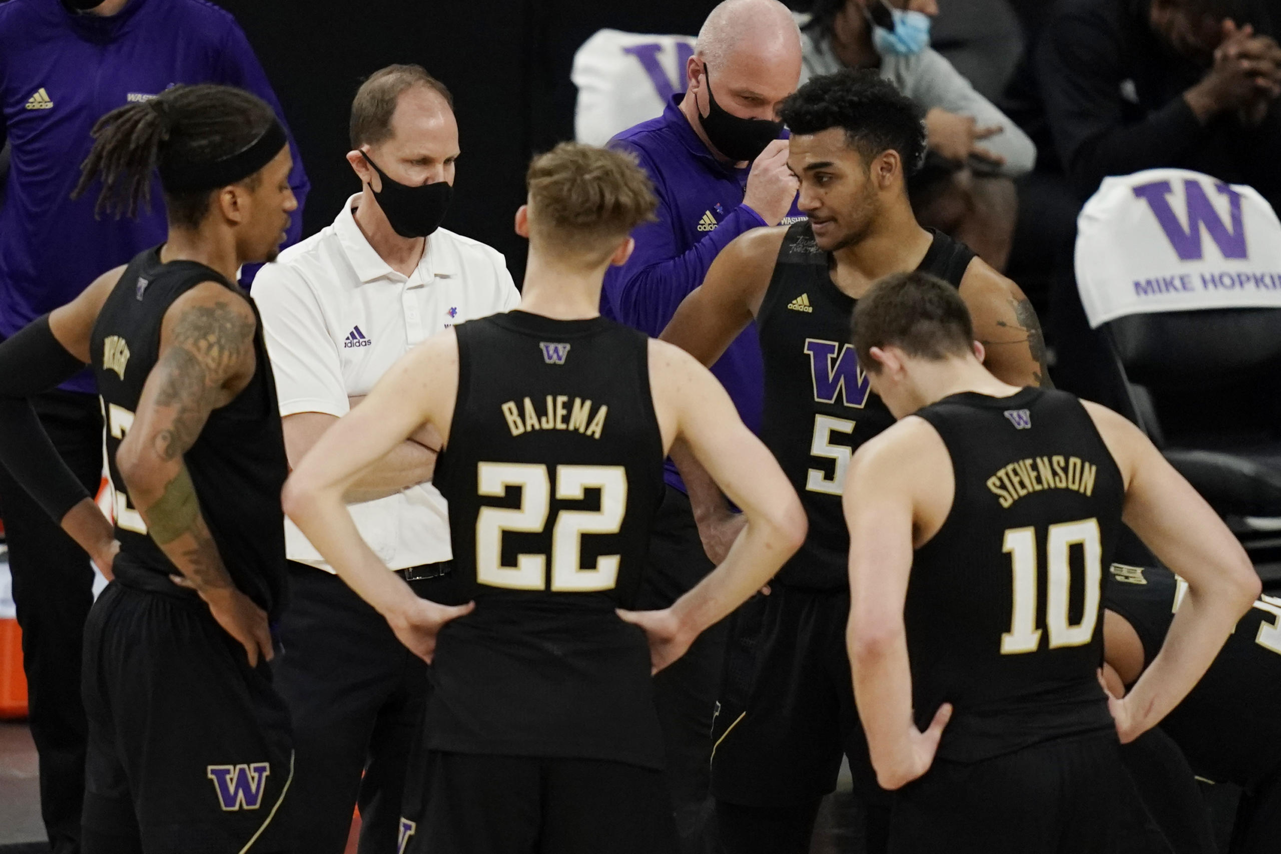 Washington head coach Mike Hopkins speaks with his players during the second half of an NCAA college basketball game in the first round of the Pac-12 men's tournament Wednesday, March 10, 2021, in Las Vegas.