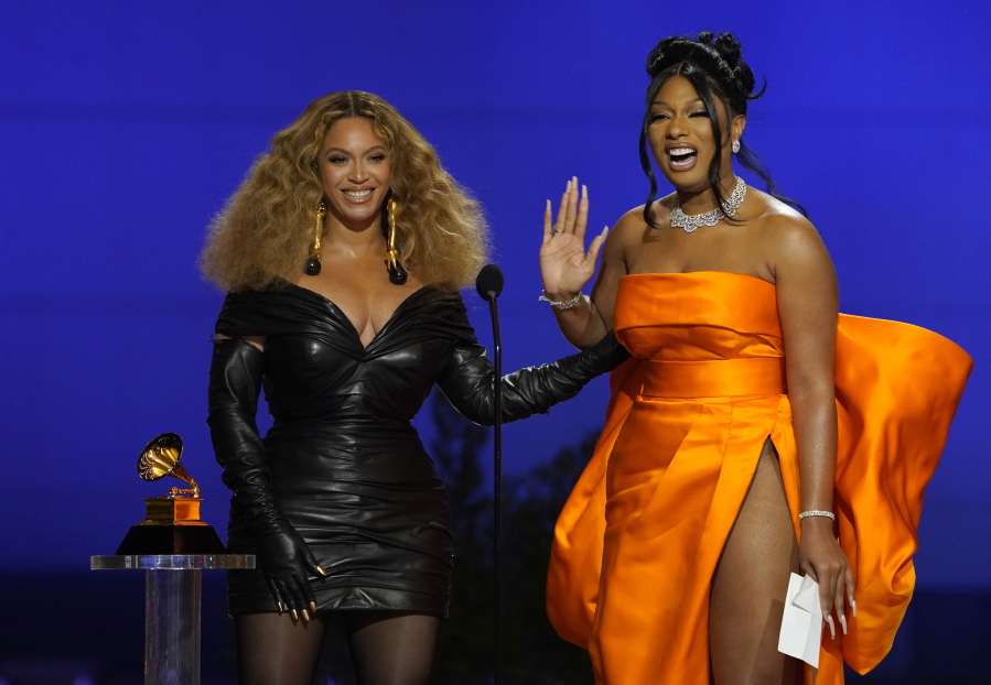 Beyonce, left, and Megan Thee Stallion accept the award for best rap song for &quot;Savage&quot; at the 63rd annual Grammy Awards at the Los Angeles Convention Center on Sunday, March 14, 2021.