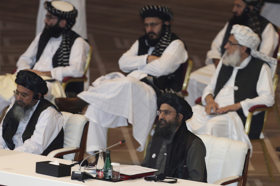 FILE - In this Sept. 12, 2020, file photo, Taliban co-founder Mullah Abdul Ghani Baradar, bottom right, speaks at the opening session of peace talks between the Afghan government and the Taliban in Doha, Qatar. Russia is to host on Thursday, March 18, 2021, the first of three international conferences aimed at jump-starting a stalled Afghanistan peace process ahead of a May 1 deadline for the final withdrawal of U.S. and NATO troops from the country.
