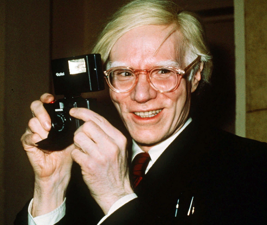 FILE - In this 1976 file photo, pop artist Andy Warhol smiles in New York. A federal appeals court sided with a photographer Friday, March 26, 2021, in her copyright dispute over how a foundation has marketed a series of Andy Warhol works of art based on her pictures of Prince.