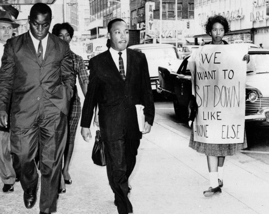 FILE - In this Oct. 19, 1960 file photo, Dr. Martin Luther King Jr. under arrest by Atlanta Police Captain R.E. Little, left rear, passes through a picket line outside Rich&#039;s Department Store, in atlanta. On King&#039;s right are Atlanta Student Movement leader Lonnie King and Spelman College student Marilyn Pryce. Holding the sign is Spelman student activist Ida Rose McCree. Following the publication of &quot;An Appeal for Human Rights&quot; on March 9, 1960, students at Atlanta&#039;s historically black colleges waged a nonviolent campaign of boycotts and sit-ins protesting segregation at restaurants, theaters, parks and government buildings.
