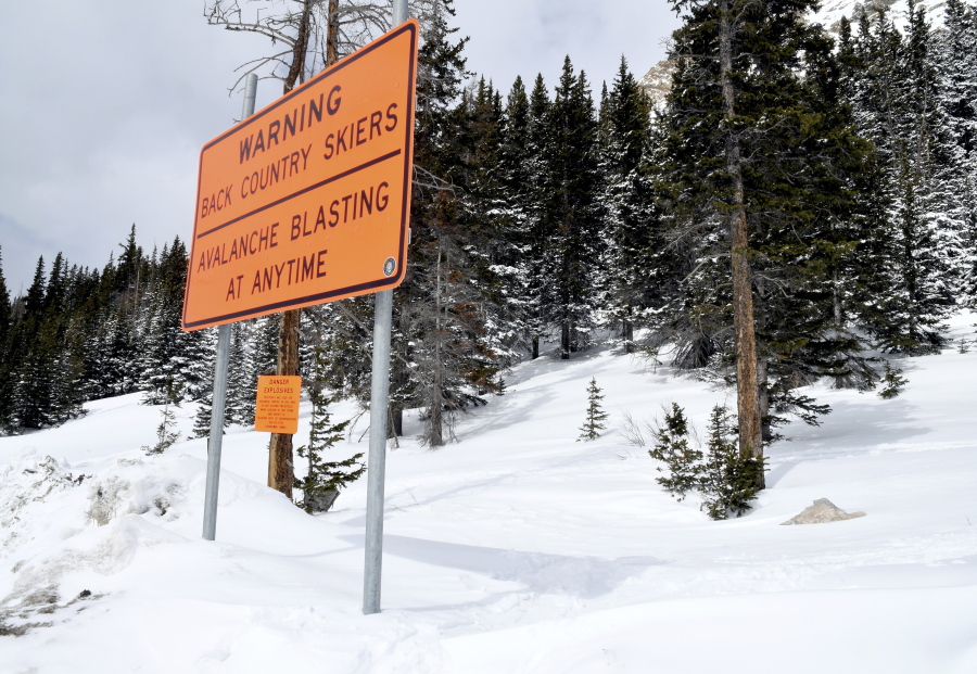 A sign warns backcountry users about avalanche blasting March 22 near the Continental Divide near Vail, Colo.