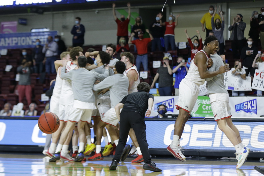 Eastern Washington players celebrate a 65-55 win over Montana State during an NCAA college basketball game for the championship of the Big Sky men&#039;s tournament in Boise, Idaho, Saturday, March 13, 2021.