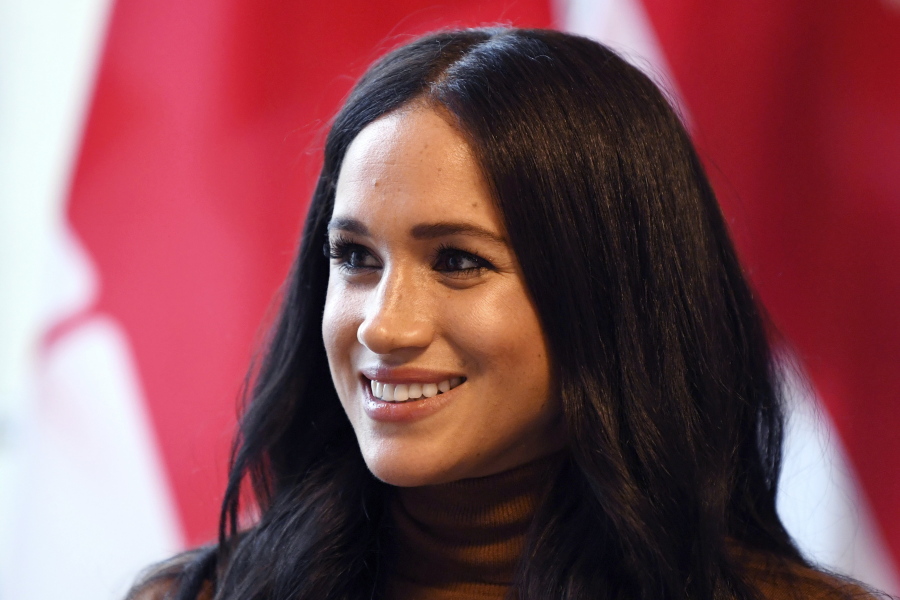 FILE - In this Tuesday, Jan. 7, 2020 file photo, Meghan, Duchess of Sussex smiles during her visit with Prince Harry to Canada House, in London. Buckingham Palace said Wednesday, March 3, 2021 it was launching an investigation after a newspaper reported that a former aide had made a bullying allegation against the Duchess of Sussex.