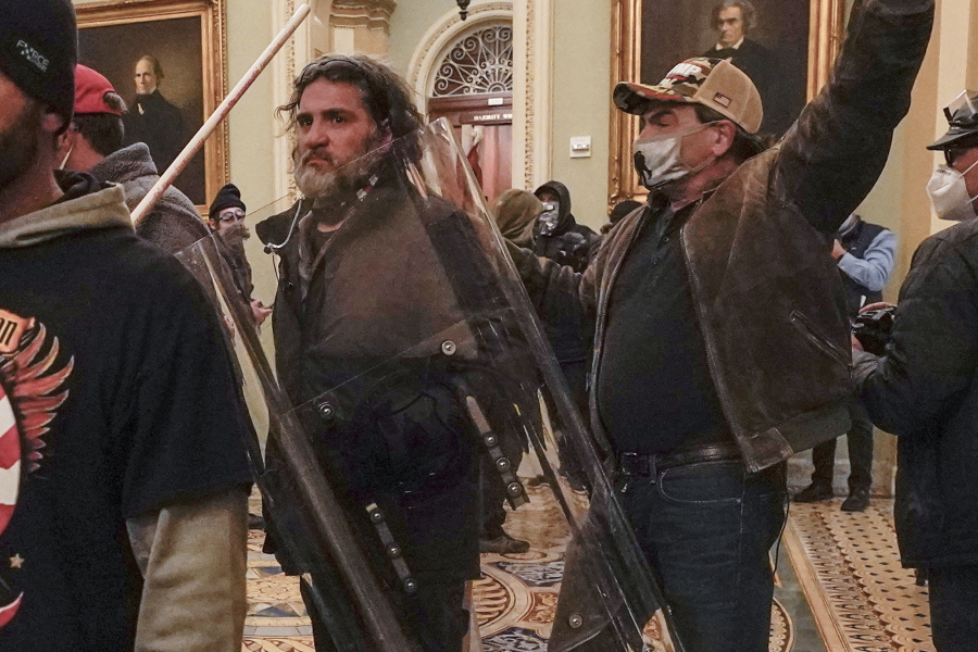 In this Jan. 6, 2021, photo, rioters, including Dominic Pezzola, center with police shield, are confronted by U.S. Capitol Police officers outside the Senate Chamber inside the Capitol, Wednesday, Jan. 6, 2021, in Washington. The Proud Boys and Oath Keepers make up a fraction of the more than 300 Trump supporters charged so far in the siege that led to Trump&#039;s second impeachment and resulted in the deaths of five people, including a police officer. But several of their leaders, members and associates have become the central targets of the Justice Department&#039;s sprawling investigation.