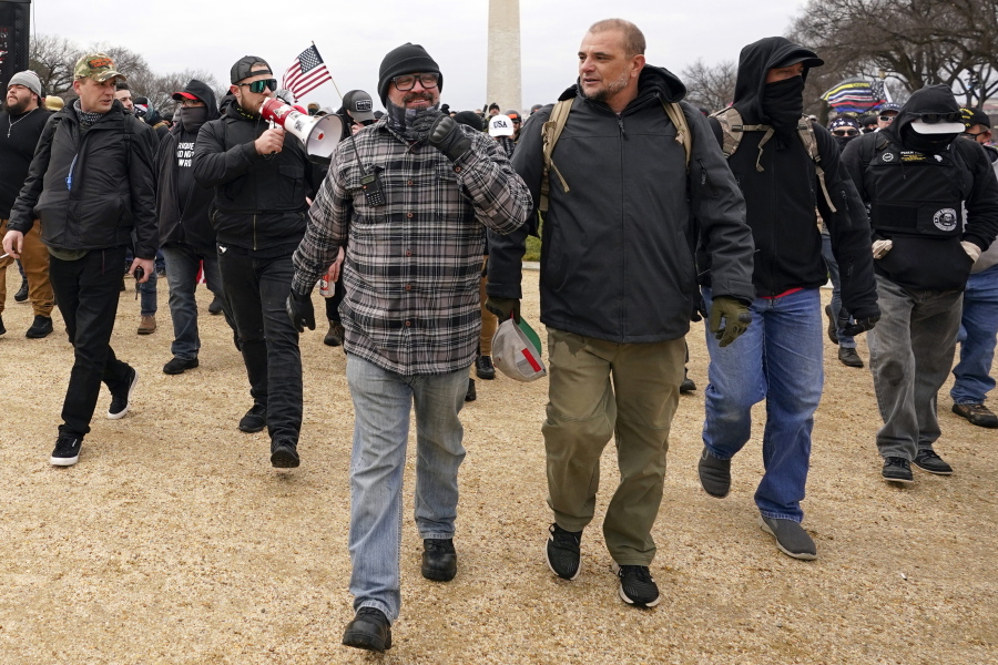 In this Jan. 6, 2021, photo, Proud Boys including Joseph Biggs, front left, walks toward the U.S. Capitol in Washington, in support of President Donald Trump. With the megaphone is Ethan Nordean, second from left. The Proud Boys and Oath Keepers make up a fraction of the more than 300 Trump supporters charged so far in the siege that led to Trump&#039;s second impeachment and resulted in the deaths of five people, including a police officer. But several of their leaders, members and associates have become the central targets of the Justice Department&#039;s sprawling investigation.