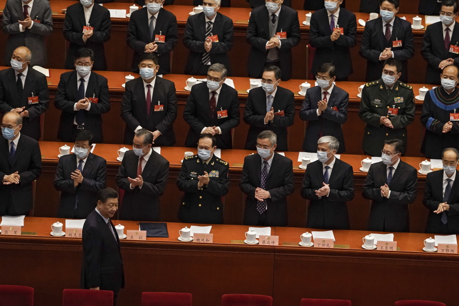 Delegates wearing face masks to help curb the spread of the coronavirus applaud as Chinese President Xi Jinping arrives for the opening session of Chinese People&#039;s Political Consultative Conference (CPPCC) at the Great Hall of the People in Beijing, Thursday, March 4, 2021.