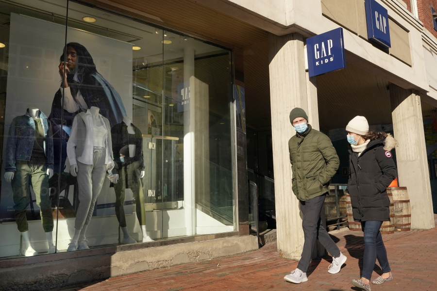 Passers-by walks near an entrance to a Gap clothing store, Thursday, Feb. 25, 2021, in Cambridge, Mass.  Bouncing back from months of retrenchment, America&#039;s consumers stepped up their spending by a solid 2.4% in January in a sign that the economy may be making a tentative recovery from the pandemic recession. Friday&#039;s report from the Commerce Department also showed that personal incomes, which provide the fuel for spending, jumped 10% last month, boosted by cash payments most Americans received from the government.