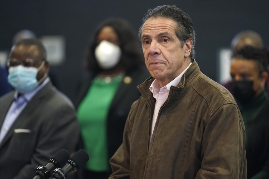FILE - In this Feb. 22, 2021 photo, New York Gov. Andrew Cuomo, right, pauses to listen to a reporter&#039;s question during a news conference at a COVID-19 vaccination site in the Brooklyn borough of New York. New York&#039;s attorney general said she&#039;s moving forward with an investigation into sexual harassment allegations against the governor after receiving a letter from his office Monday authorizing her to take charge of the probe.