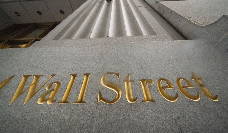 FILE - In this Nov. 5, 2020 file photo, a sign for Wall Street is carved in the side of a building.  Stocks are opening higher on Wall Street led by gains in Big Tech companies. The S&amp;P 500 was up 0.4% early Wednesday, March 31, 2021.