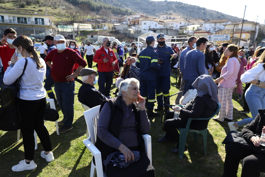 Local residents gather at a soccer field after an earthquake in Mesochori village, central Greece, Wednesday, March 3, 2021. An earthquake with a preliminary magnitude of up to 6.3 struck central Greece on Wednesday and was felt as far away as the capitals of neighboring Albania, North Macedonia, Kosovo and Montenegro.