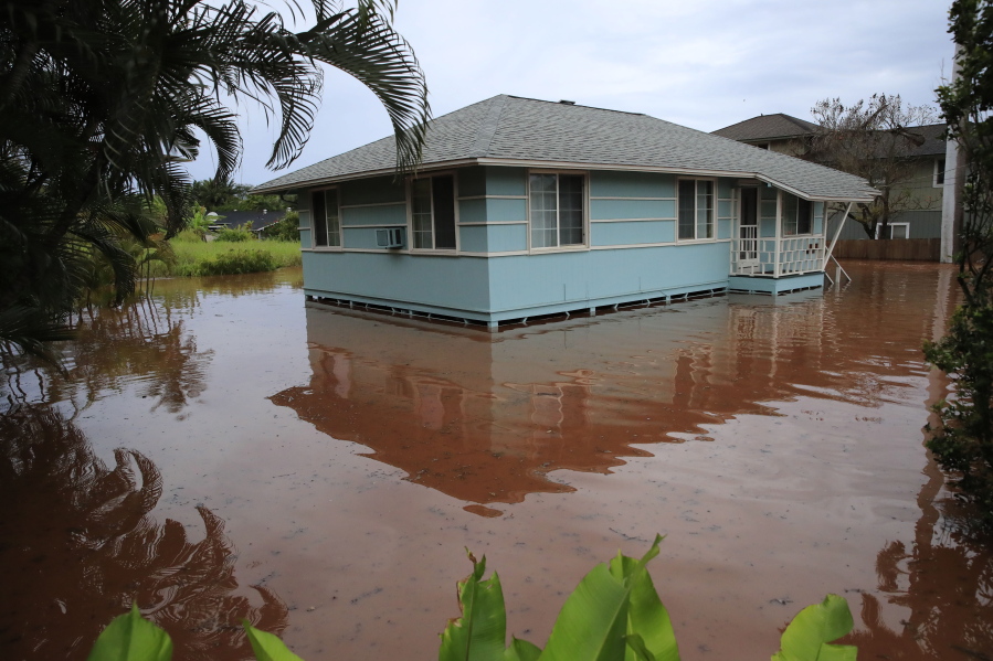 A house on Haleiwa Road is surrounded by floodwaters Tuesday, March 9, 2021, in Haleiwa, Hawaii. Torrential rains have inundated parts of Hawaii for the past several days.
