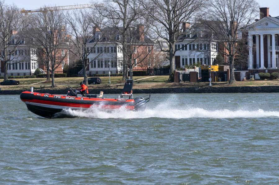 In this Friday March 19, 2021, photo a District of Columbia Fire Boat checks buoys in the waterway next to Fort McNair, seen in background in Washington. Iran has made threats against Fort McNair, a U.S. army base in Washington DC, and against the Army&#039;s vice chief of staff, according to two senior U.S. intelligence officials, who spoke on condition of anonymity to discuss national security matters. The threats are one reason the Army has been pushing for more security around the base, which sits alongside the bustling Waterfront district of Washington DC.