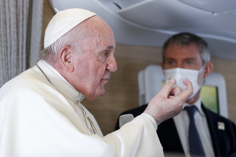Pope Francis speaks to journalists, Monday, March 8, 2021, while flying back to The Vatican at the end of his four-day trip to Iraq where he met with different Christian communities and Shiite revered cleric Grand Ayatollah Ali al-Sistani. At right pope&#039;s spokesperson Matteo Bruni.