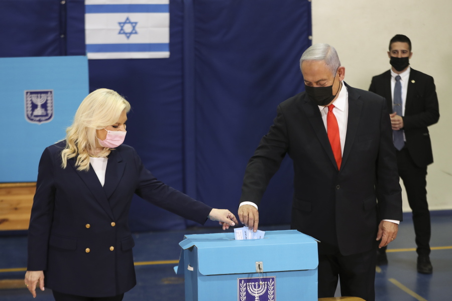 Israeli Prime Minister Benjamin Netanyahu and his wife Sara cast their ballots at a polling station as Israelis vote in a general election, in Jerusalem , Tuesday, March 23, 2021. Israelis began voting on Tuesday in the country&#039;s fourth parliamentary election in two years - a highly charged referendum on the divisive rule of  Netanyahu.