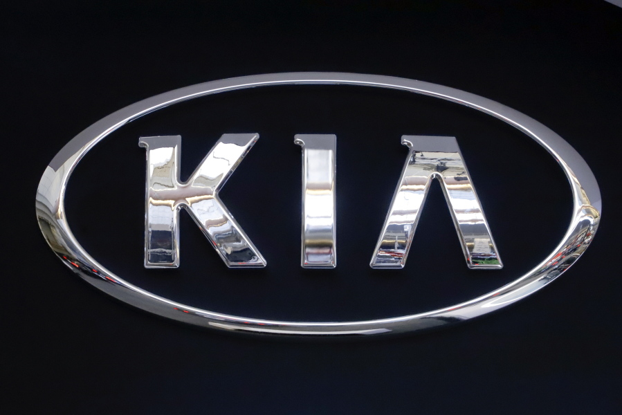 FILE - In this Feb. 14, 2019 file photo, the KIA logo is displayed on a sign at the 2019 Pittsburgh International Auto Show in Pittsburgh. Kia is telling owners of nearly 380,000 vehicles in the U.S. to park them outdoors due to the risk of an engine compartment fire. The Korean automaker is recalling certain 2017 through 2021 Sportage SUVs and 2017 through 2019 Cadenza sedans to fix the problem. (AP Photo/Gene J.