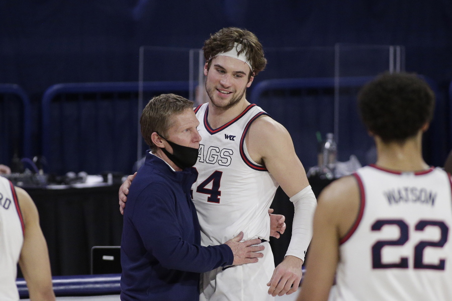 Gonzaga coach Mark Few, left, hugs forward Corey Kispert after Kispert, a senior playing his last home game, left the court near the end of the second half of the team&#039;s NCAA college basketball game against Loyola Marymount in Spokane, Wash., Saturday, Feb. 27, 2021. Gonzaga won 86-69.
