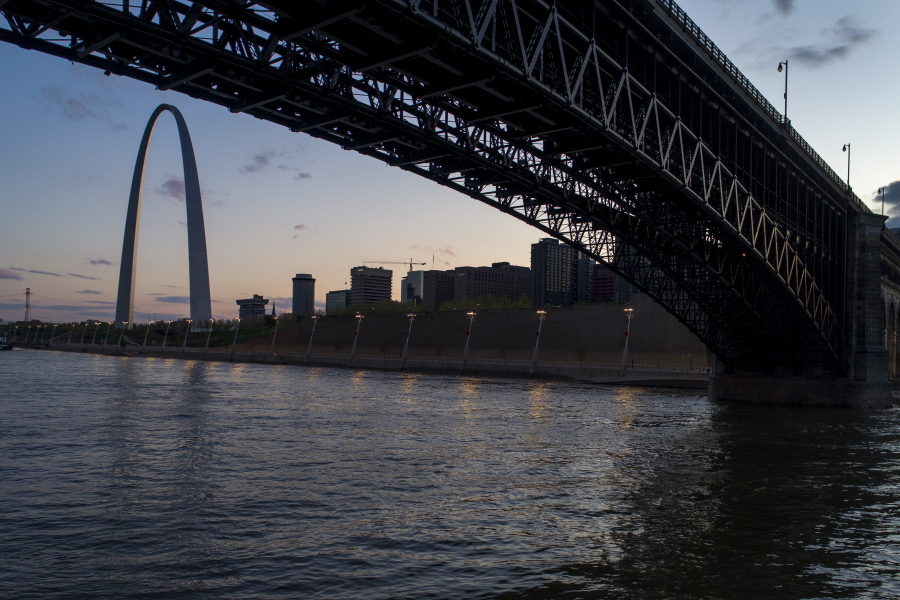 FILE - The Eads Bridge crosses the Mississippi River from Illinois to Missouri as the sun sets beyond the Gateway Arch, Tuesday, April 14, 2020, in St. Louis. Cities along the Mississippi River will take part in a global system to determine where plastic pollution comes from and how it ends up in waterways as a first step toward solving the problem, officials said Wednesday, March 3, 2021.