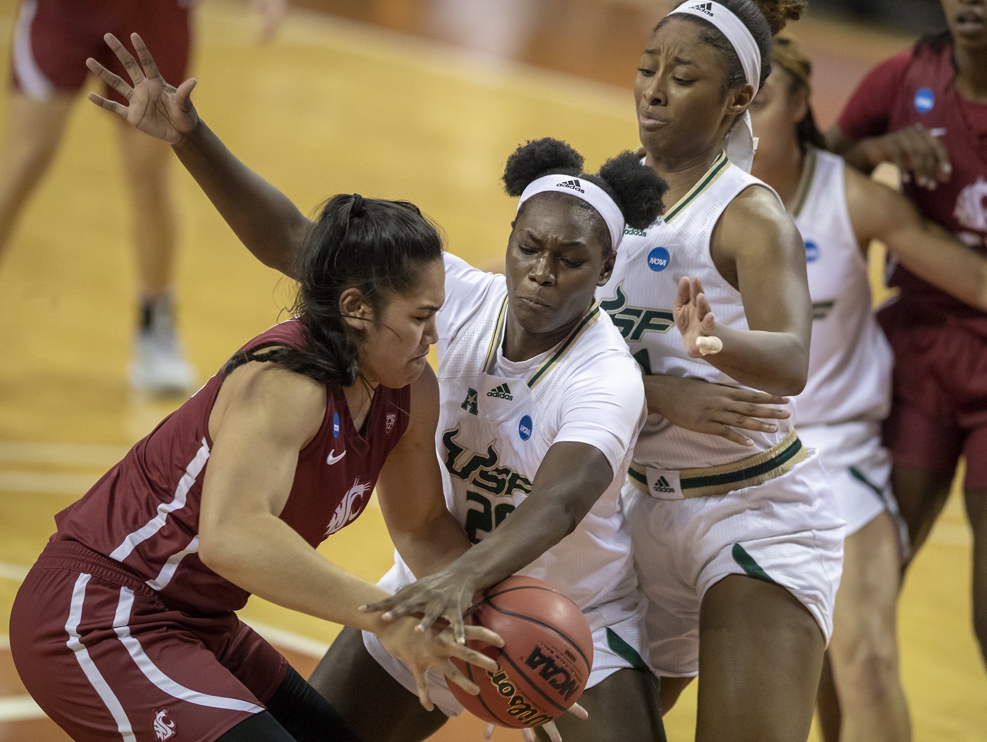 Washington State forward Ula Motuga (15), left, drives against South Florida forward Bethy Mununga (20), center, and South Florida center Shae Leverett (21), right, during the second quarter of a college basketball game in the first round of the women's NCAA tournament at the Frank Erwin Center in Austin, Texas, Sunday, March 21, 2021. (Ricardo B.