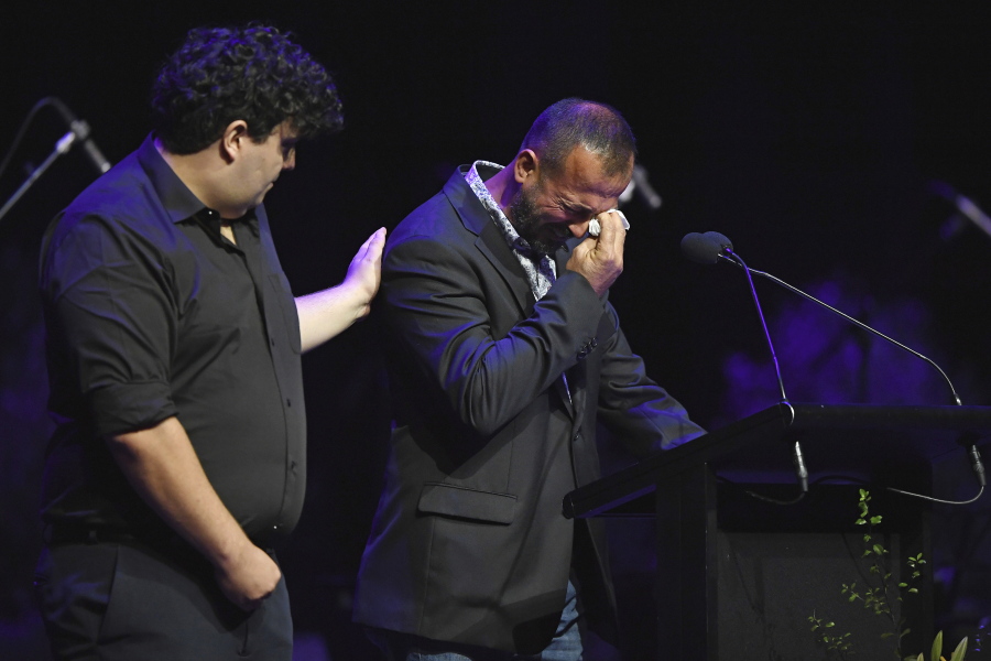 Temel Atacocugu, right, who survived being shot nine times during the attack on the Al Noor mosque, cries as he speaks at a National Remembrance Service, Saturday, March 13, 2021, in Christchurch, New Zealand. The service marks the second anniversary of a shooting massacre in which 51 worshippers were killed at two Christchurch mosques by a white supremacist.