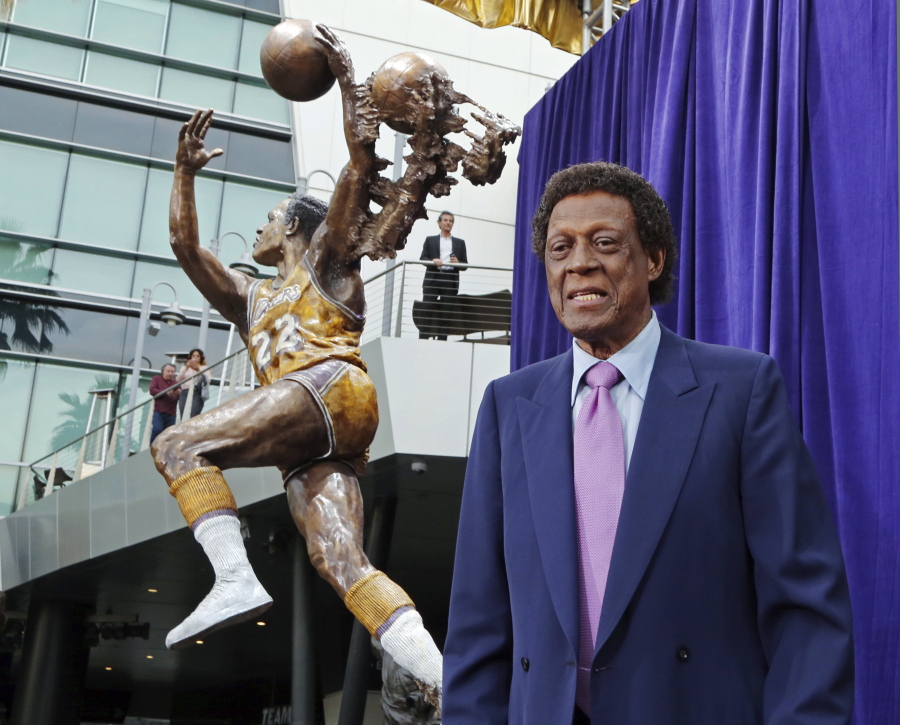 FILE - Elgin Baylor stands next to a statue, just unveiled, honoring the Minneapolis and Los Angeles Lakers great, outside Staples Center in Los Angeles, in this Friday, April 6, 2018, file photo. Elgin Baylor, the Lakers&#039; 11-time NBA All-Star, died Monday, March 22, 2021, of natural causes. He was 86. The Lakers announced that Baylor died in Los Angeles with his wife, Elaine, and daughter Krystal by his side.