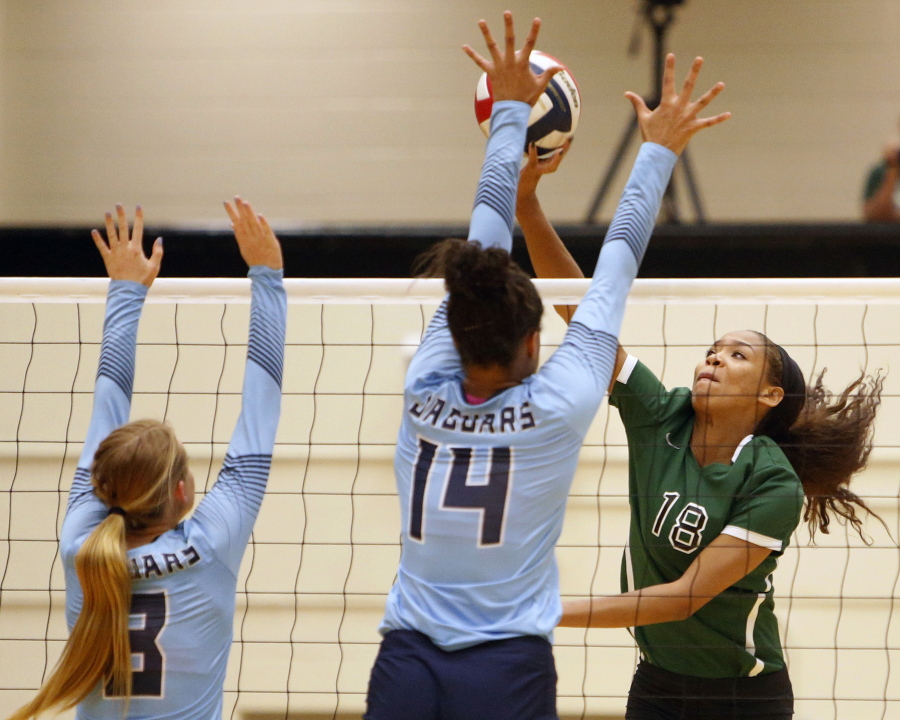 FILE - Reagan&#039;s Kyla Waiters, right, spikes the ball past Johnson defenders during a Texas District 26-6A high school volleyball match in San Antonio, Texas, in this Friday, Sept. 22, 2017, file photo. Oregon State leaders are suing to block disclosure of details about an investigation of abuse allegations in their volleyball program, even as they tout a refreshed mission for transparency in wake of their president&#039;s resignation over the handling of sexual-misconduct cases at another school. &quot;I&#039;m guessing there&#039;s something in those records that they don&#039;t want out,&quot; said Dorina Waiters, whose daughter, Kyla, left Oregon State after a year on the volleyball team triggered depression that led to suicidal thoughts.