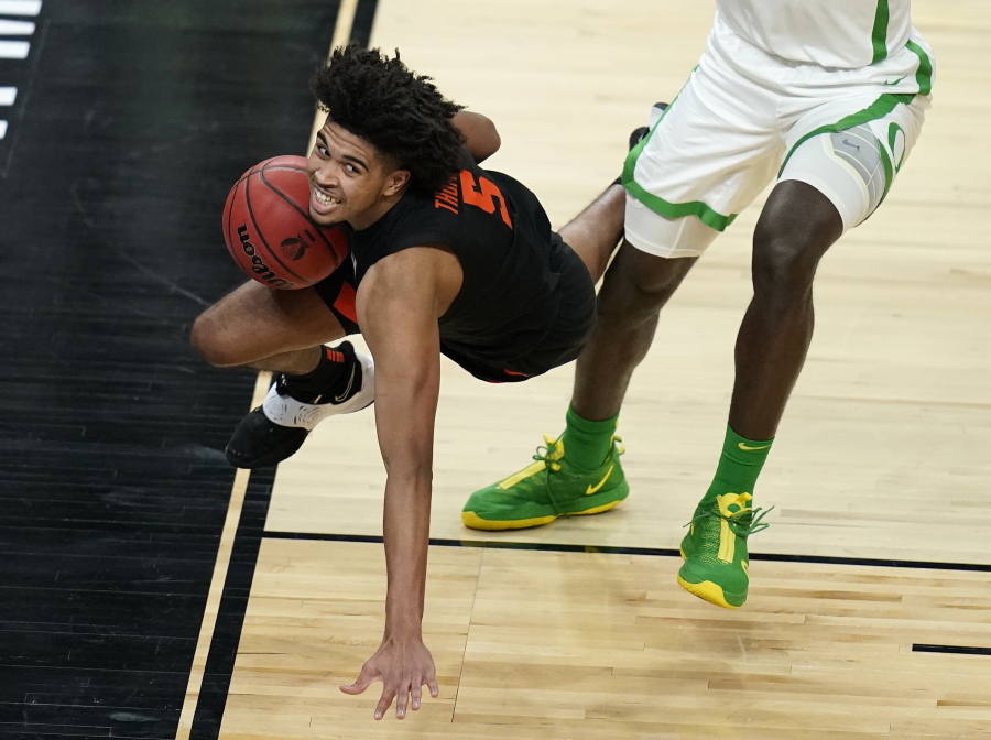 Oregon&#039;s Franck Kepnang, right, fouls Oregon State&#039;s Ethan Thompson (5) during the first half of an NCAA college basketball game in the semifinal round of the Pac-12 men&#039;s tournament Friday, March 12, 2021, in Las Vegas.