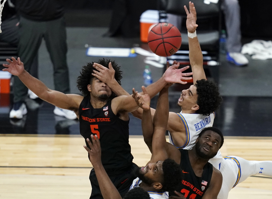 Oregon State&#039;s Ethan Thompson, clockwise from top left, UCLA&#039;s Jules Bernard, Oregon State&#039;s Rodrigue Andela, and UCLA&#039;s Cody Riley (2) vie for a rebound during the second half of an NCAA college basketball game in the quarterfinal round of the Pac-12 men&#039;s tournament Thursday, March 11, 2021, in Las Vegas.