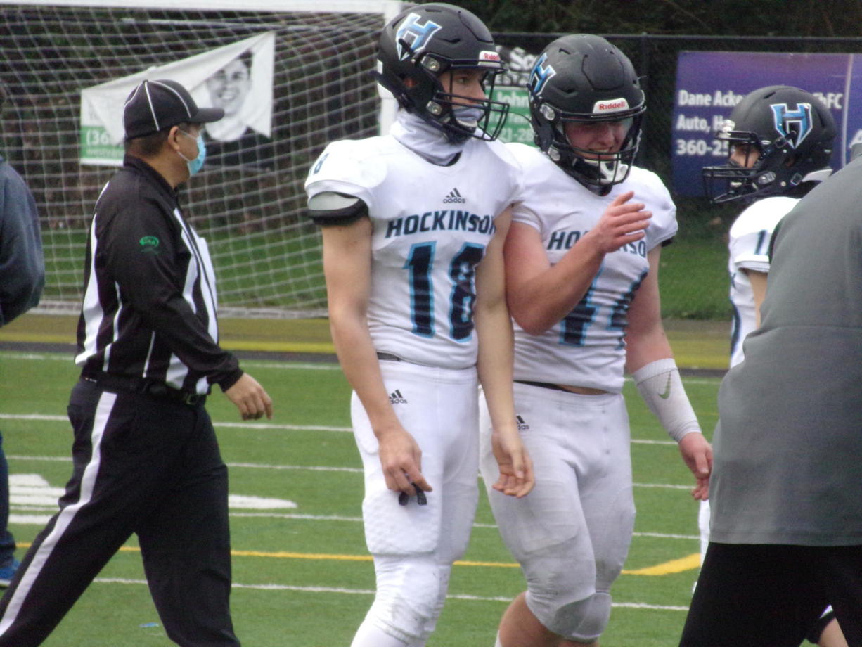 Hockinson's Jarod Oldham (18) and Cody Wheeler (44) walks off the field after sealing a 16-6 win over Columbia River on March 6, 2021 (Tim Martinez/The Columbian)