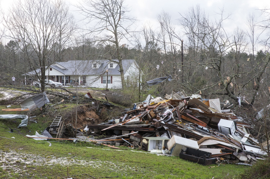 Debris litters weather-damaged properties at the intersection of County Road 24 and 37 in Clanton, Ala., the morning following a large outbreak of severe storms across the southeast, Thursday, March 18, 2021.