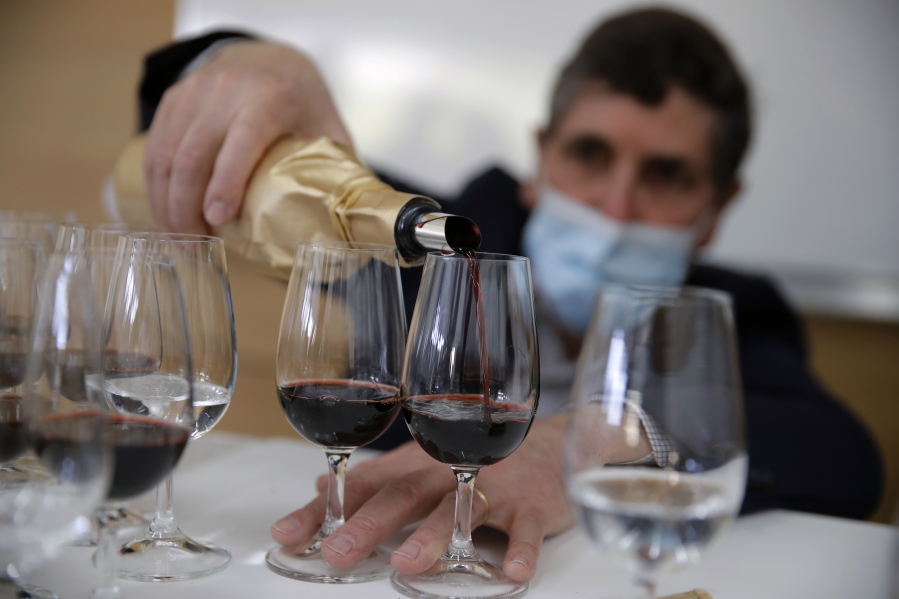 Philippe Darriet, president of the Institute for Wine and Vine Research and head oenologist fills glasses with wine for a blind tasting March 1 at the ISVV Institute in Villenave-d&#039;Ornon, southwestern France.
