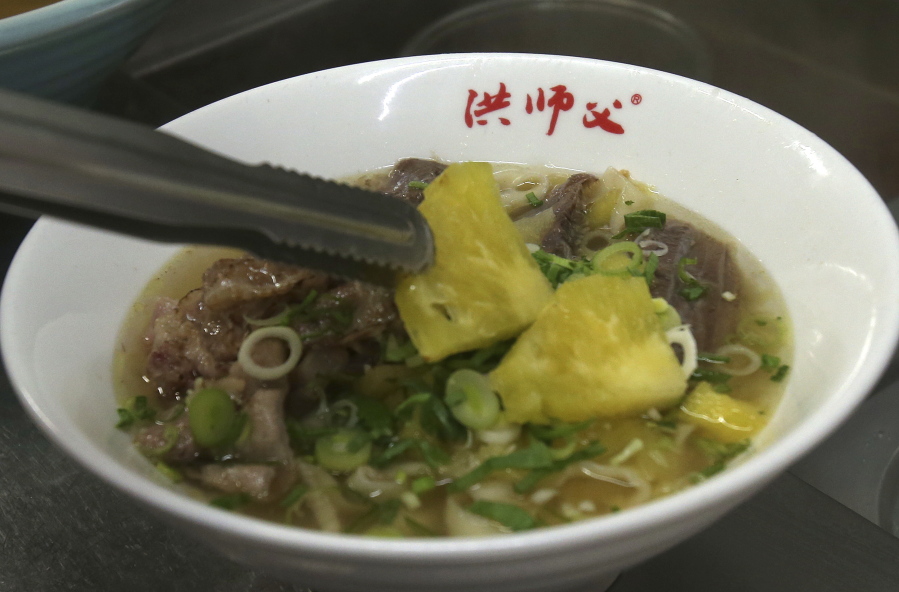 Chef Hung cooks pineapple beef noodle at his restaurant in Taipei, Taiwan, Wednesday, March 10, 2021. Hung Ching Lung, a Taipei chef, has created a pineapple beef noodle soup at his eponymous restaurant Chef Hung, in what he says is a modest attempt to support Taiwanese pineapple farmers.
