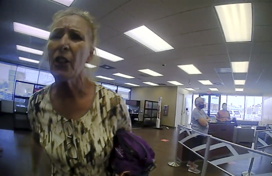 This frame grab from police body cam video provided by the Galveston Police Department, in Galveston, Texas, shows Terry Wright, 65, of Grants Pass, Oregon, arguing with an officer inside a Bank of America branch, Thursday, March 11, 2021, in Galveston, after being told she needed to leave the bank because she was not wearing a face mask, amid the coronavirus pandemic.