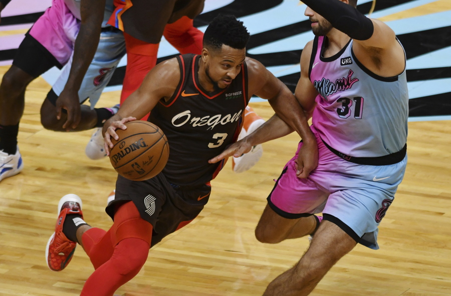 Portland Trail Blazers guard CJ McCollum (3) drives as Miami Heat guard Max Strus (31) defends during the first half of an NBA basketball game Thursday, March 25, 2021, in Miami.