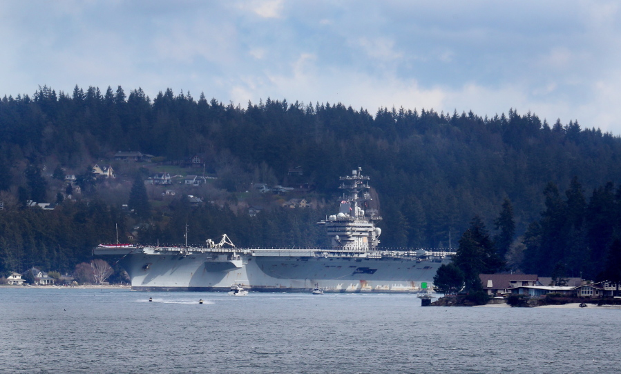 The USS Nimitz emerges from Rich Passage, a narrow tidal strait in Puget Sound, en route to Naval Station Bremerton on Sunday.