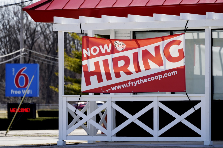 A hiring sign shows outside of restaurant in Prospect Heights, Ill., Sunday, March 21, 2021.  The number of people seeking unemployment benefits fell sharply last week to 684,000, the fewest since the pandemic erupted a year ago and a sign the economy is improving.  (AP Photo/Nam Y.